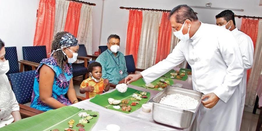 Fr Paul Karedan serving Onasadya to Jin and his mother at Lisie Hospital