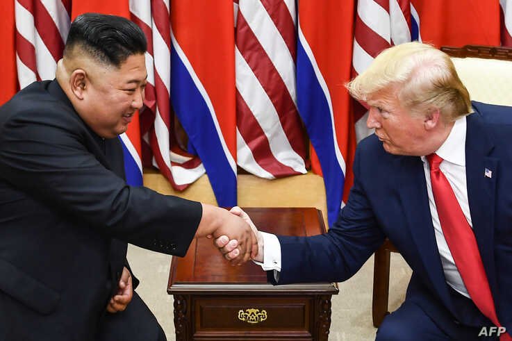 North Korea's leader Kim Jong Un (L) and US President Donald Trump shake hands during a meeting on the south side of the Military Demarcation Line that divides North and South Korea.