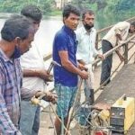 Ongoing repair work on the 242-meter-long rail walkway created in 1981. Though worn down, it has been helping people of the area reach the mainland easily