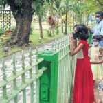 A child looks eagerly at the play equipment inside the Subhash Bose Park which will be reopened for the public.