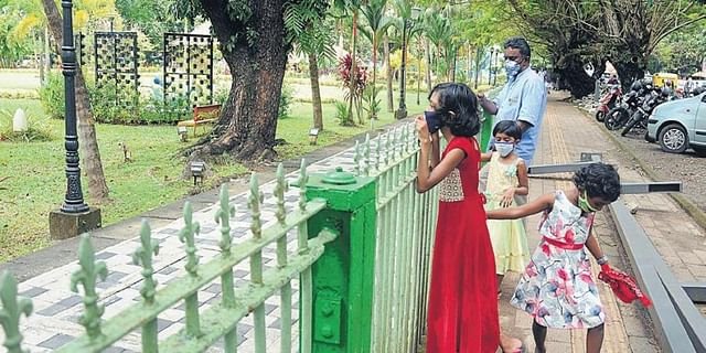 A child looks eagerly at the play equipment inside the Subhash Bose Park which will be reopened for the public.
