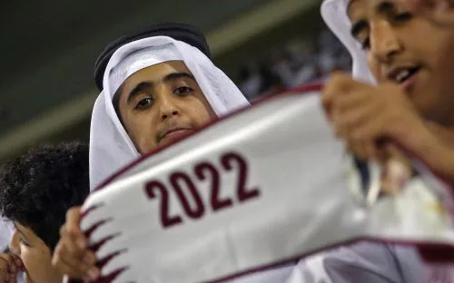 Qatari football fan cheers for his team