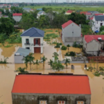Flooded village in Vietnam after Typhoon Yagi, homes submerged and crops destroyed by torrential rains.