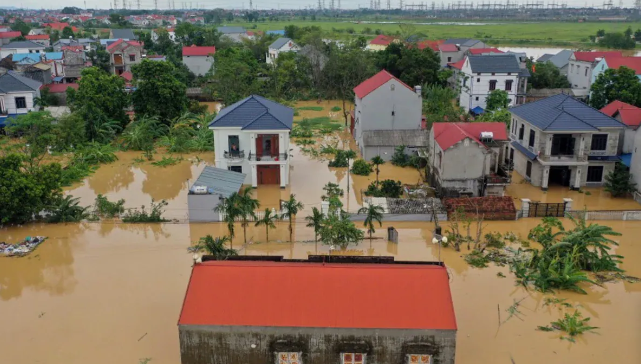 Flooded village in Vietnam after Typhoon Yagi, homes submerged and crops destroyed by torrential rains.