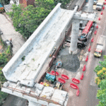 Workers installing a U-girder on the Kochi Metro Pink Line viaduct